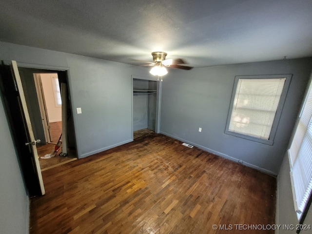 unfurnished bedroom with a closet, ceiling fan, and wood-type flooring