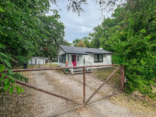 view of front of property featuring a garage and an outbuilding