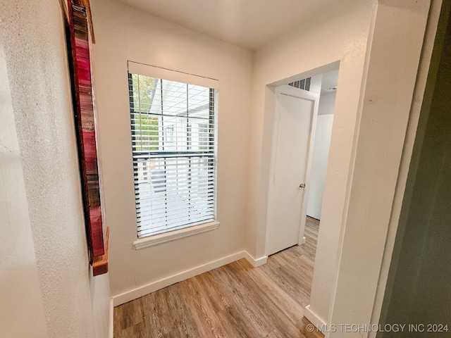 hall with light hardwood / wood-style floors