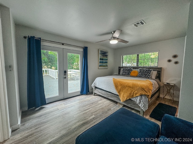 bedroom featuring multiple windows, ceiling fan, access to exterior, and french doors