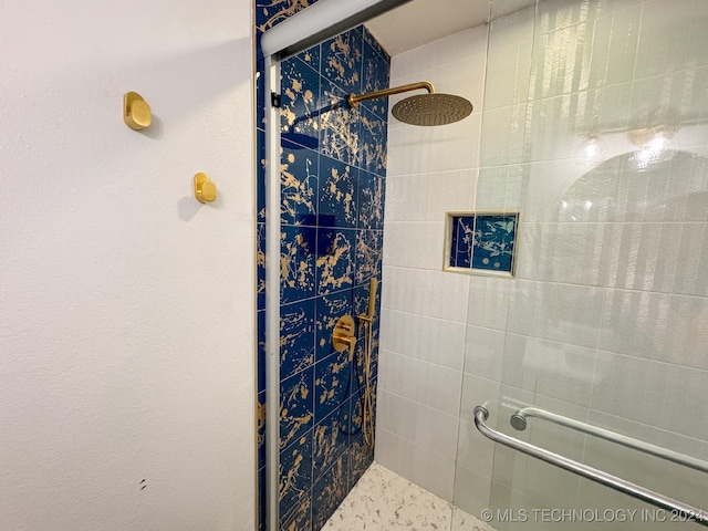 bathroom featuring a shower with shower door