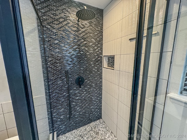 bathroom with a tile shower