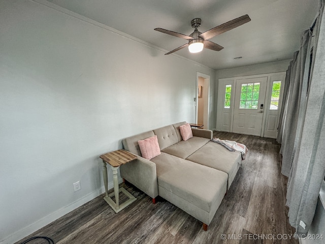 living room with ceiling fan, dark hardwood / wood-style flooring, and crown molding