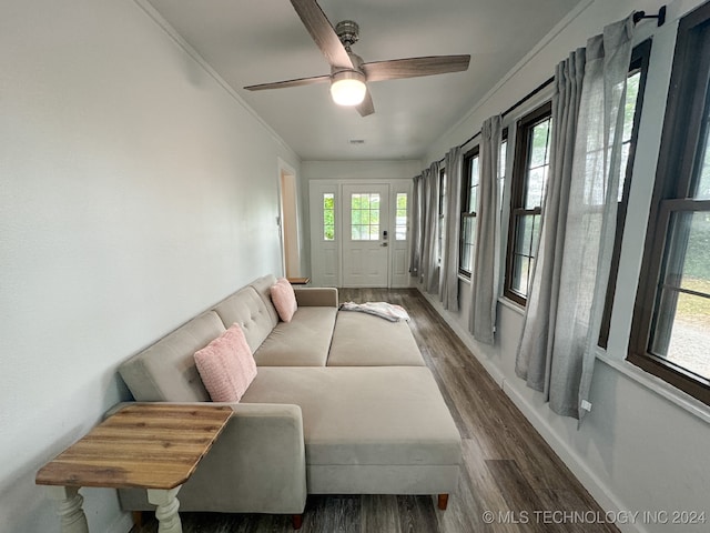 sunroom featuring ceiling fan and plenty of natural light