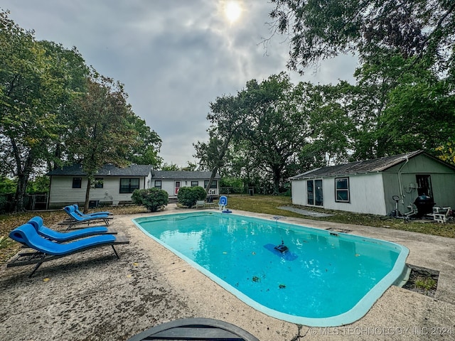 view of swimming pool with a patio area