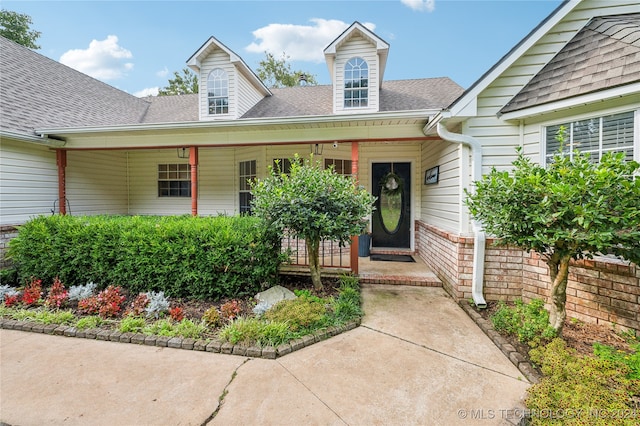 doorway to property featuring covered porch