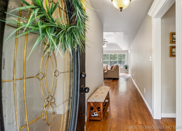 hallway with hardwood / wood-style floors