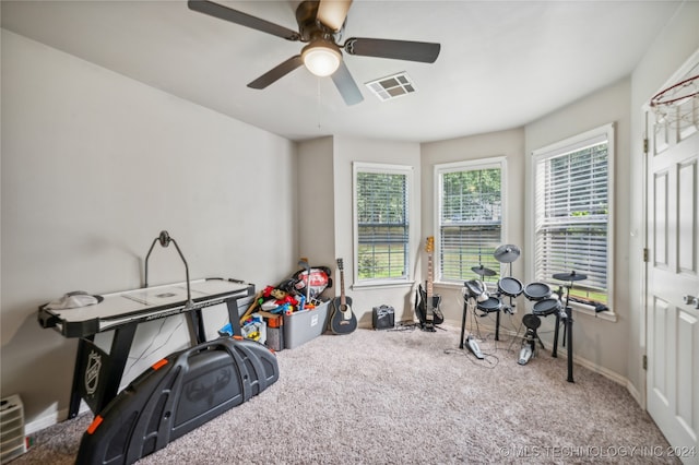 interior space with ceiling fan and carpet floors