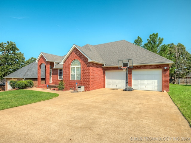 view of front of property with a garage and a front yard