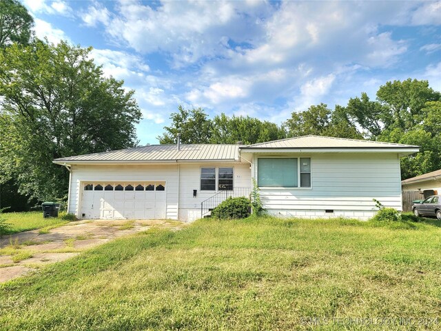 ranch-style house with a garage and a front yard