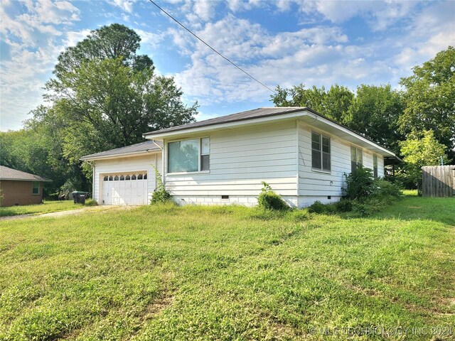 ranch-style house with a front lawn and a garage