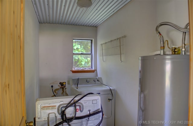 laundry room with water heater and washer / dryer