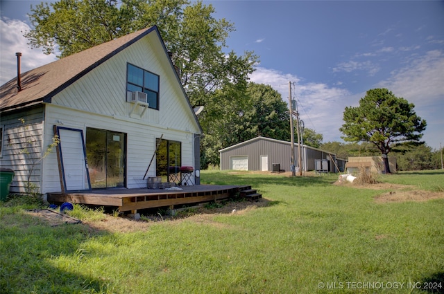 rear view of property featuring cooling unit, a yard, and a deck