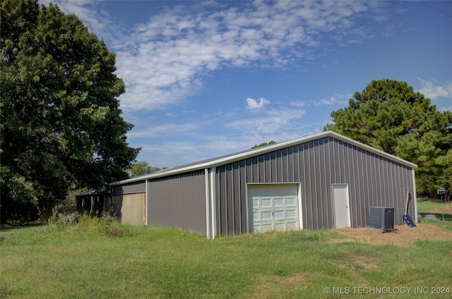 view of outdoor structure featuring central AC and a garage