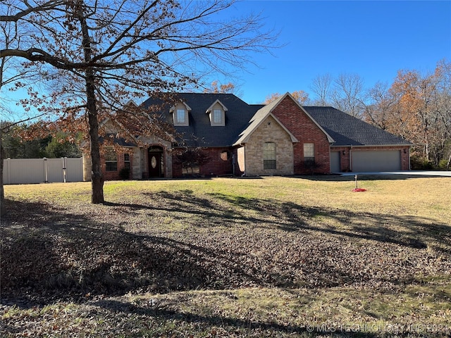 view of front of house featuring a front yard and a garage