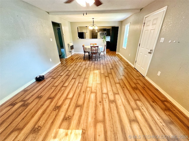 unfurnished dining area with light wood-type flooring and ceiling fan with notable chandelier