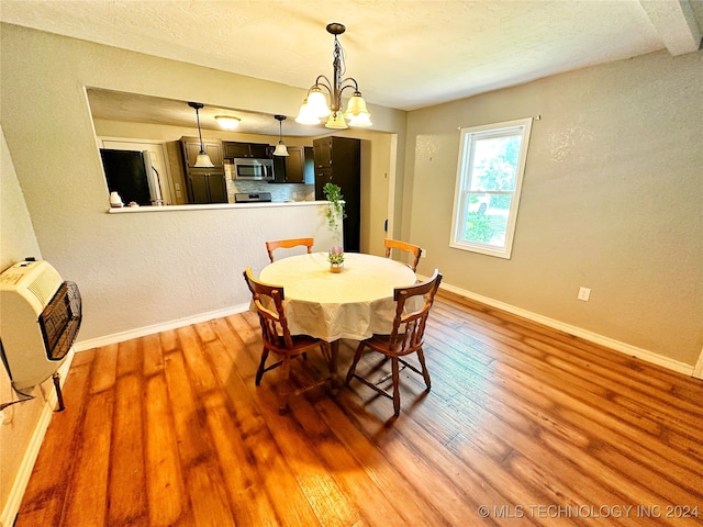 dining room featuring an inviting chandelier and hardwood / wood-style floors