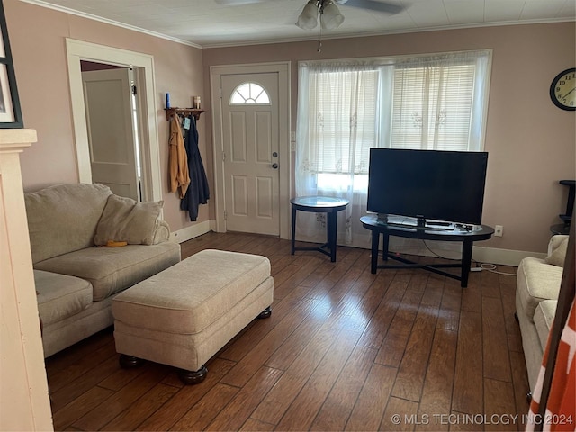 living room featuring baseboards, ceiling fan, wood-type flooring, and crown molding