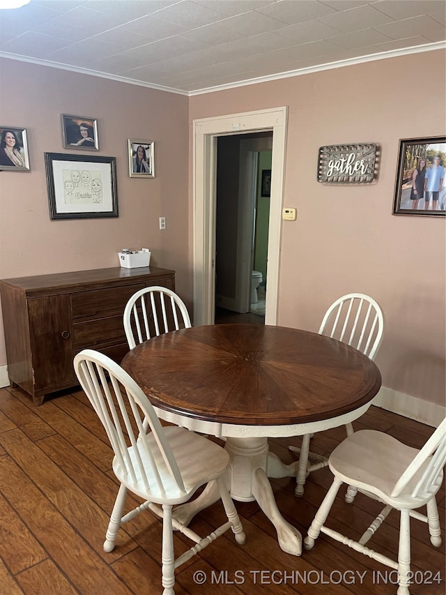 dining area featuring hardwood / wood-style flooring and ornamental molding