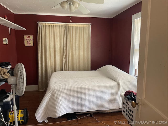 bedroom with ceiling fan, ornamental molding, and wood finished floors