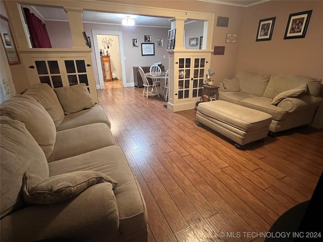 living room with light wood-type flooring and ornamental molding