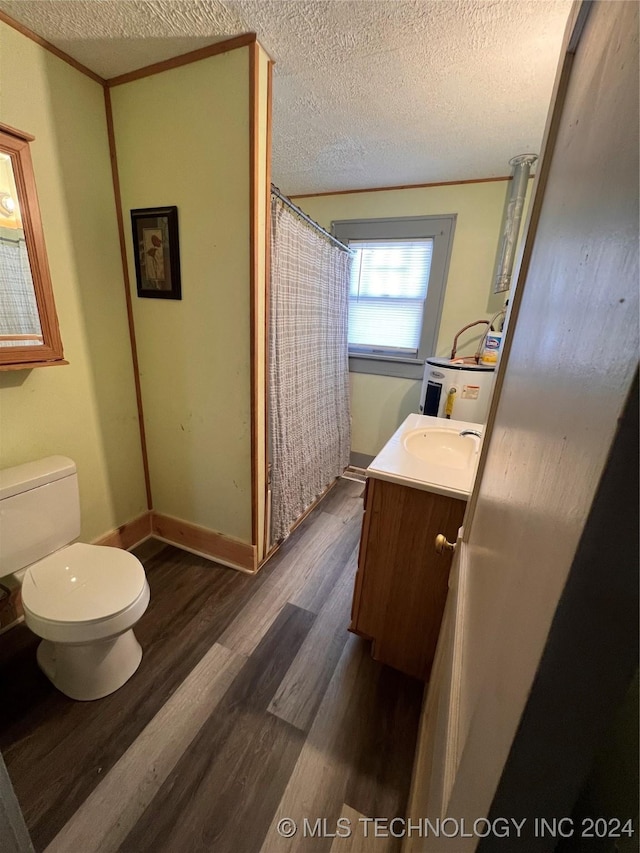 bathroom with vanity, crown molding, toilet, a textured ceiling, and wood-type flooring