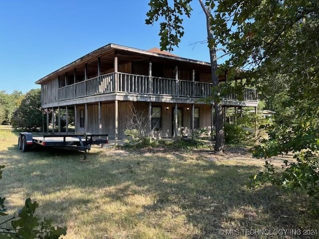 rear view of house featuring a wooden deck