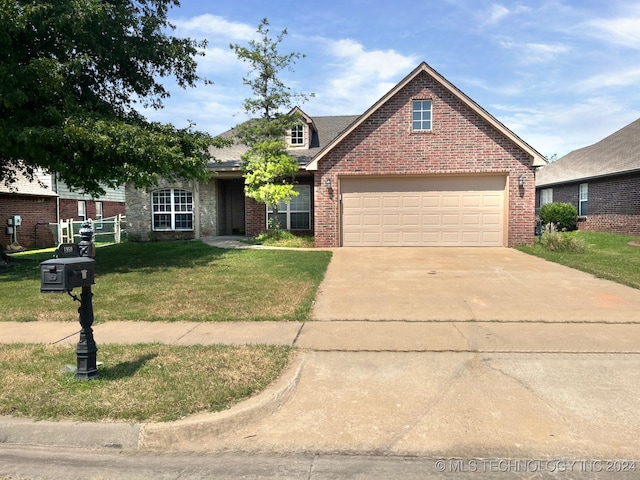 view of front of property featuring a garage and a front yard