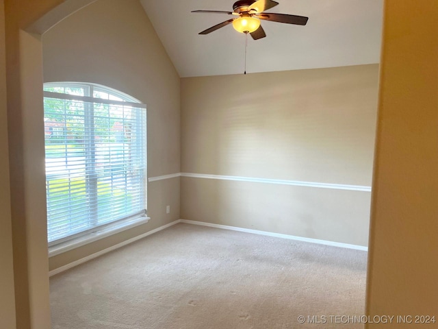 unfurnished room featuring vaulted ceiling, ceiling fan, carpet flooring, and a healthy amount of sunlight