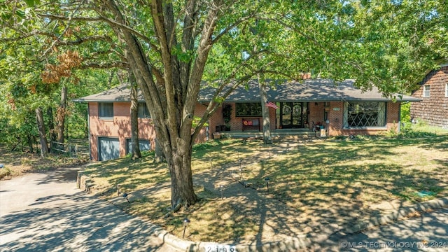 view of front of home featuring a garage and a front lawn