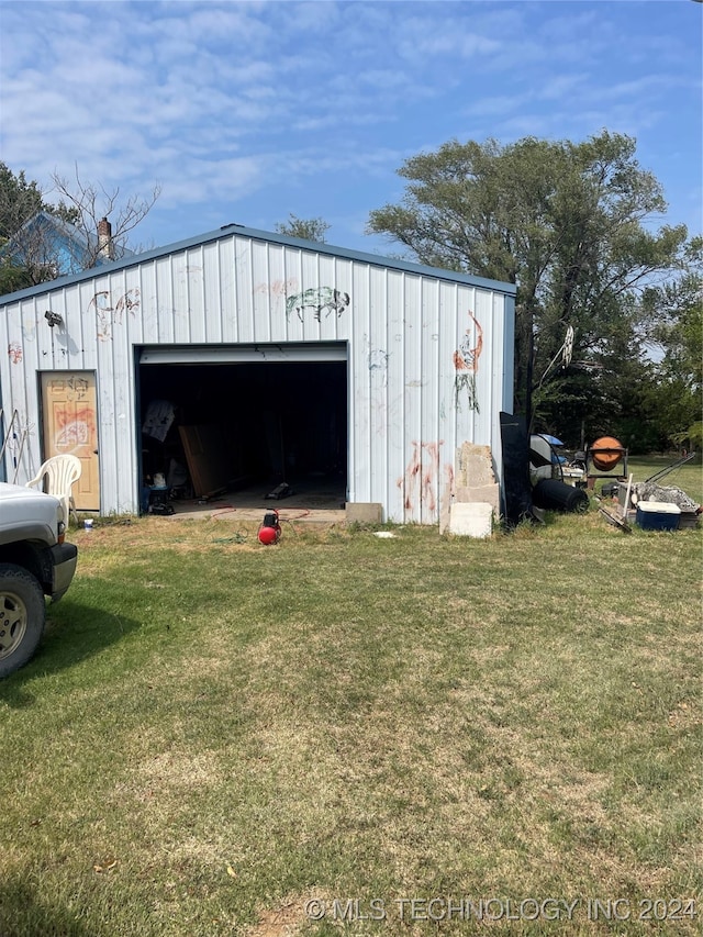 view of outbuilding featuring a garage and a yard