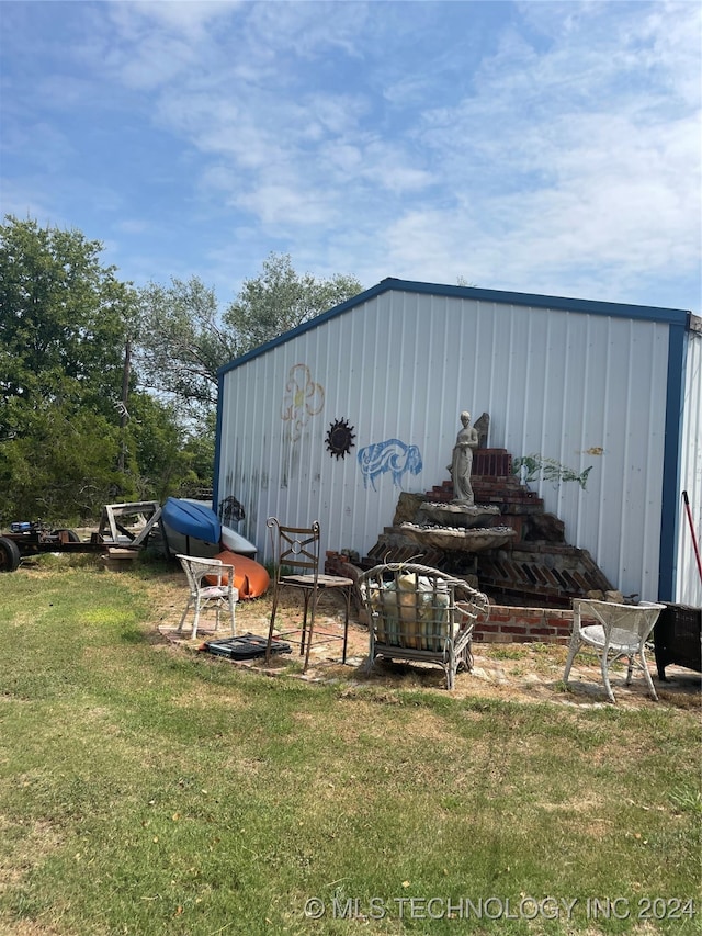 view of outdoor structure featuring a lawn