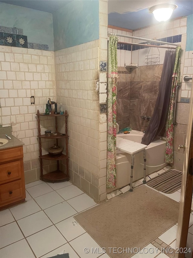 full bathroom with tile patterned flooring, tile walls, shower / tub combo with curtain, and vanity