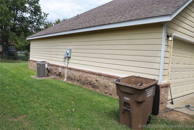 view of property exterior featuring a yard, a garage, and central AC unit