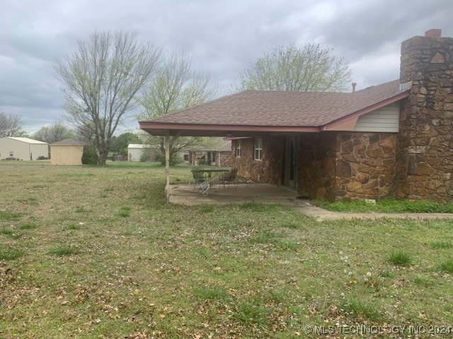 back of house featuring a patio and a lawn