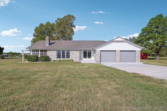 ranch-style house featuring a garage and a front yard