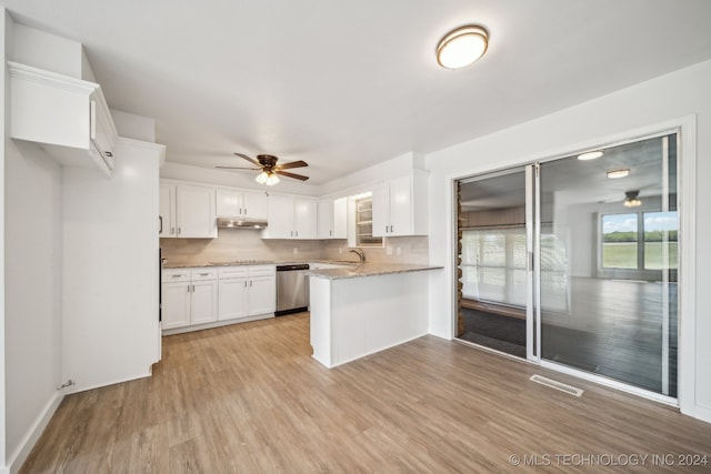 kitchen featuring light wood-type flooring, white cabinetry, ceiling fan, tasteful backsplash, and stainless steel dishwasher