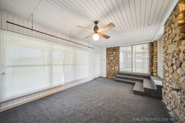 unfurnished sunroom with ceiling fan