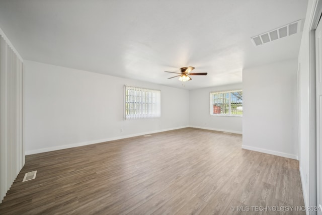 unfurnished room featuring hardwood / wood-style floors and ceiling fan