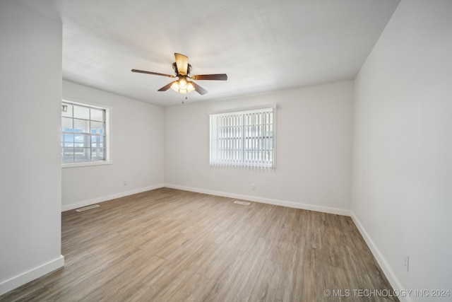 empty room with light hardwood / wood-style flooring and ceiling fan