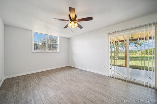 empty room with ceiling fan and wood-type flooring