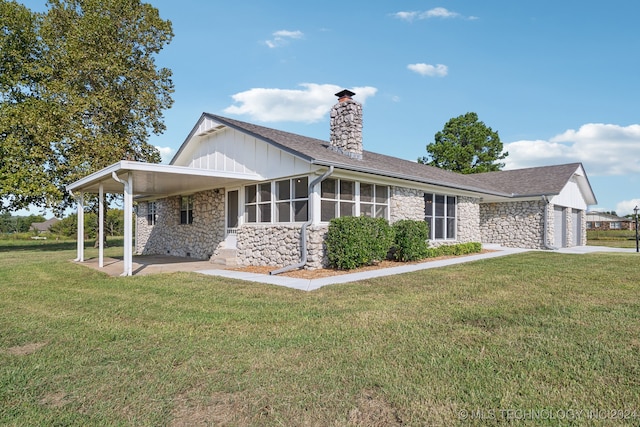 exterior space featuring a garage and a front lawn