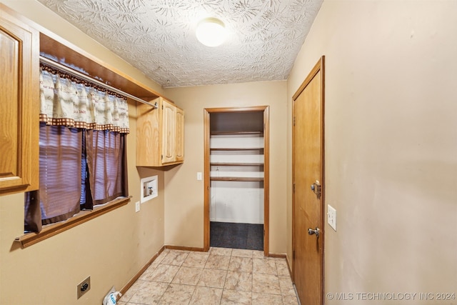 laundry room featuring washer hookup, light tile patterned floors, cabinets, and hookup for an electric dryer