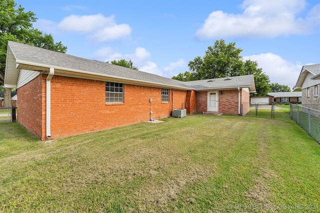 rear view of property with a lawn