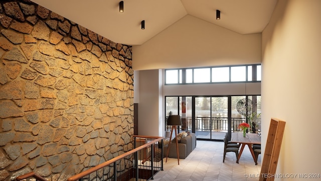 interior space with high vaulted ceiling and light parquet floors