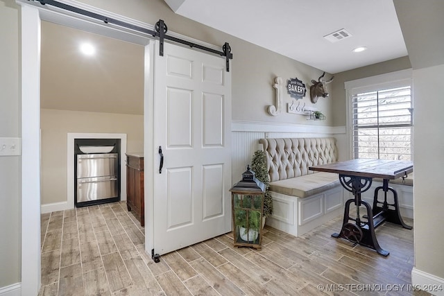 interior space featuring light hardwood / wood-style floors and a barn door