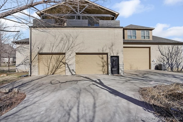 exterior space with a garage and cooling unit