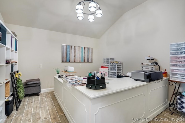 office area with light hardwood / wood-style flooring, vaulted ceiling, and an inviting chandelier