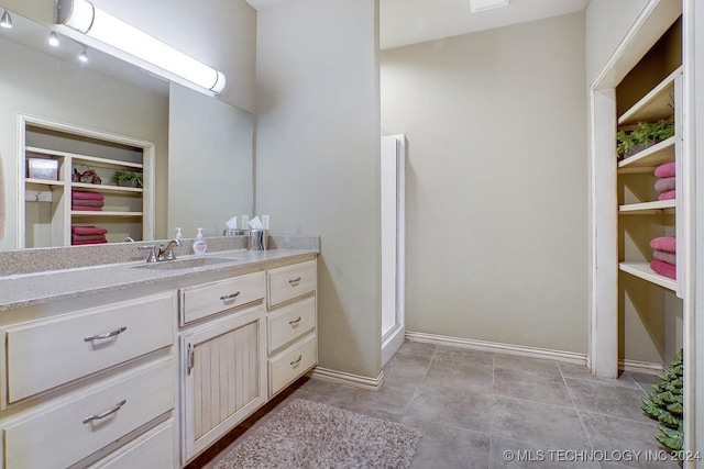 bathroom with tile patterned flooring and vanity