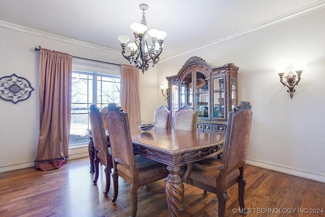 dining room featuring hardwood / wood-style flooring, crown molding, and a chandelier